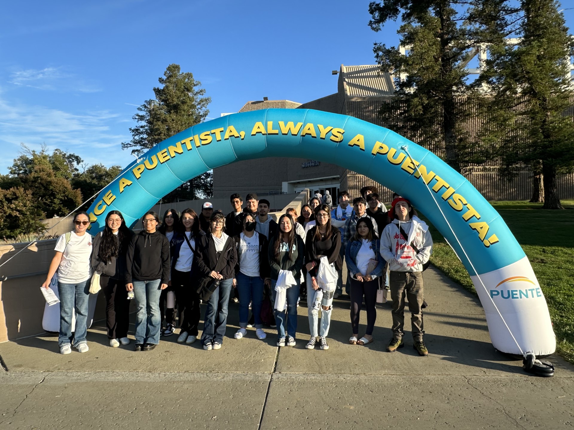 students in front of green arch at UC Davis
